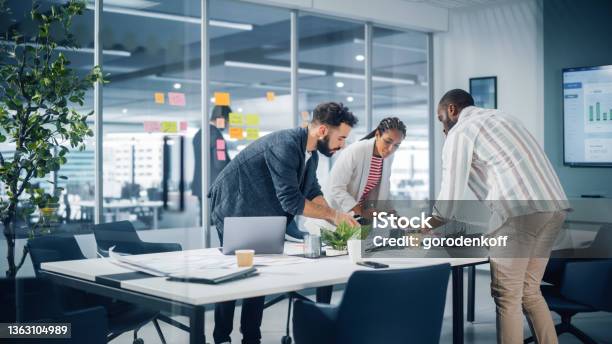 Diverse Team Of Professional Businesspeople Meeting In The Office Conference Room Creative Team Around Table Black Businesswoman Africanamerican Digital Entrepreneur And Hispanic Ceo Talking Stock Photo - Download Image Now