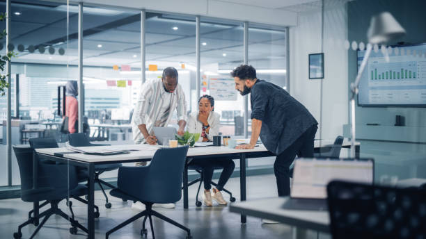 istock Multi-Ethnic Office Conference Room Meeting: Team of Three Creative Entrepreneurs Talk, Discuss Growth Strategy. Stylish Young Businesspeople work on Digital e-Commerce Startup. 1363105007