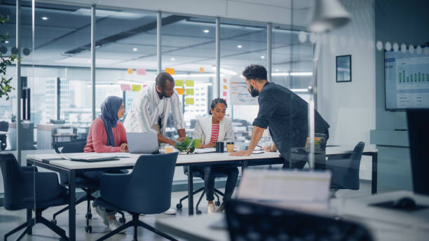 istock Multi-Ethnic Office Conference Room Meeting: Multicultural Team of Four Creative Entrepreneurs Talk, Discuss Growth Strategy. Diverse Young Businesspeople work on Digital e-Commerce Startup. 1363105010