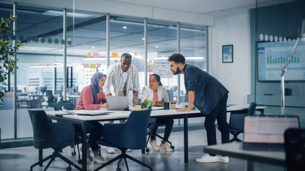 istock Multi-Ethnic Office Conference Room Meeting: Multicultural Team of Four Creative Entrepreneurs Talk, Discuss Growth Strategy. Diverse Young Businesspeople work on Digital e-Commerce Startup. 1363105024