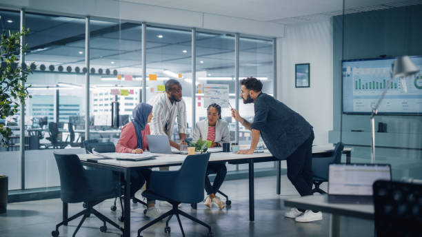 istock Multi-Ethnic Office Conference Room Meeting: Multicultural Team of Four Creative Entrepreneurs Talk, Discuss Growth Strategy. Diverse Young Businesspeople work on Digital e-Commerce Startup. 1363105069