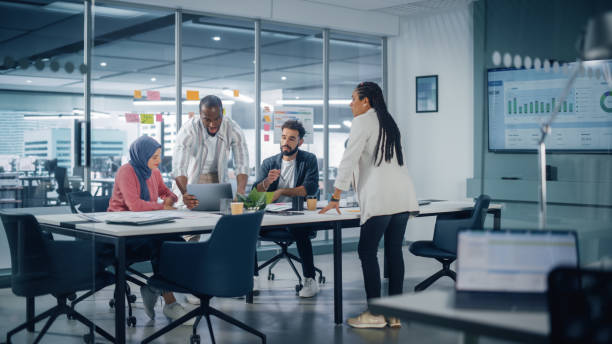 multi-ethnic office conference room meeting: multicultural team of four creative entrepreneurs talk, discuss growth strategy. diverse young businesspeople work on digital e-commerce startup. - multi ethnic group office teamwork working imagens e fotografias de stock