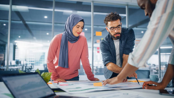 istock Multi-Ethnic Office Conference Room Meeting: Team of Three Creative Entrepreneurs Talk, Discuss Growth Strategy. Stylish Young Businesspeople work on Digital e-Commerce Startup. 1363105146