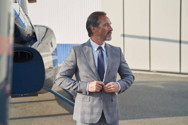 istock Tranquil mature gentleman standing near parked helicopter 1363105287