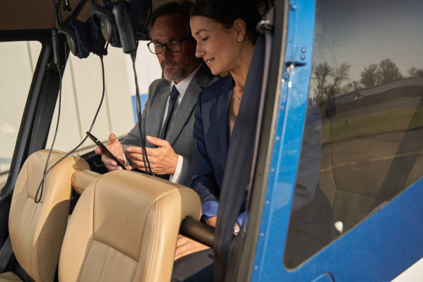 istock Lady and gentleman sitting in private helicopter 1363105324