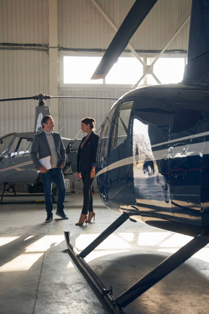 istock Two people having conversation in aircraft hangar 1363105411