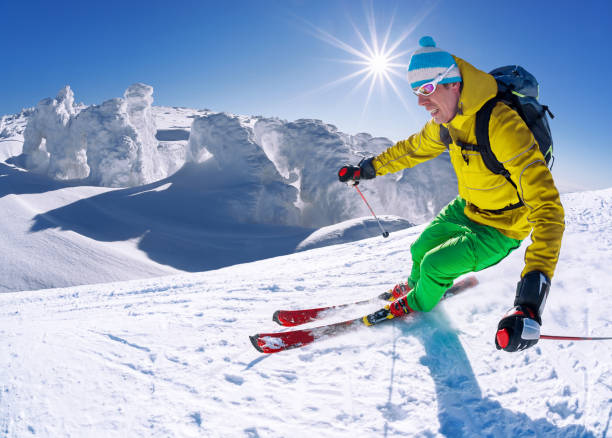 istock Skier skiing downhill in high mountains against blue sky 1363109338