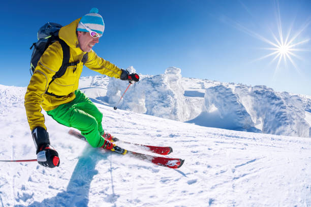 istock Skier skiing downhill in high mountains against blue sky 1363109461