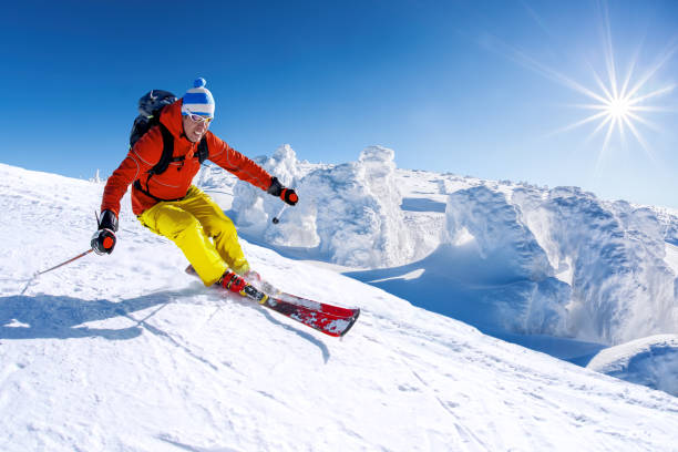 istock Skier skiing downhill in high mountains against blue sky 1363109482