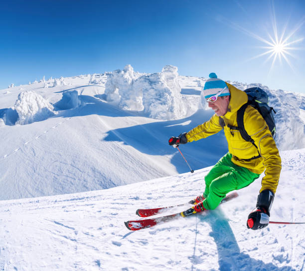 istock Skier skiing downhill in high mountains against blue sky 1363109498