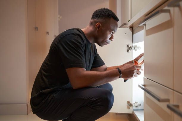 istock Male is repairing kitchen cupboard with pliers 1363110362
