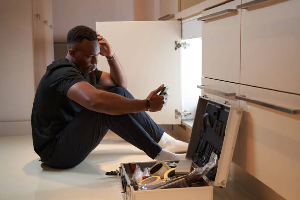 istock Frustrated man sitting near tool set with smartphone 1363110364