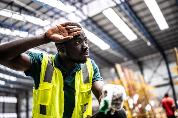 istock Tired young man working in a factory 1363110806