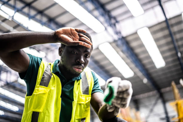 istock Tired young man working in a factory 1363110849