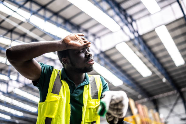 istock Tired young man working in a factory 1363110886