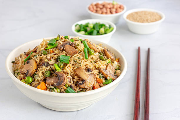 istock Asian Vegetable and Mushroom Fried Rice in a Bowl on White Background 1363111765