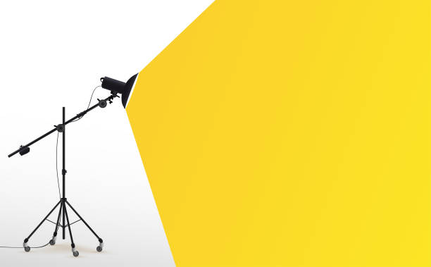 Photo studio lamp. Spotlight concept. Spotlight shines with yellow light. Place for text for your design. Vector illustration photo studio flashes light bulb icon. Photo studio lamp. Spotlight concept. Spotlight shines with yellow light. Place for text for your design. Vector illustration photo studio flashes light bulb icon. sable stock illustrations