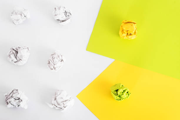 istock overhead shot of crumpled paper in oder and colored flat sheets of paper on white background. zero waste concept 1363113659