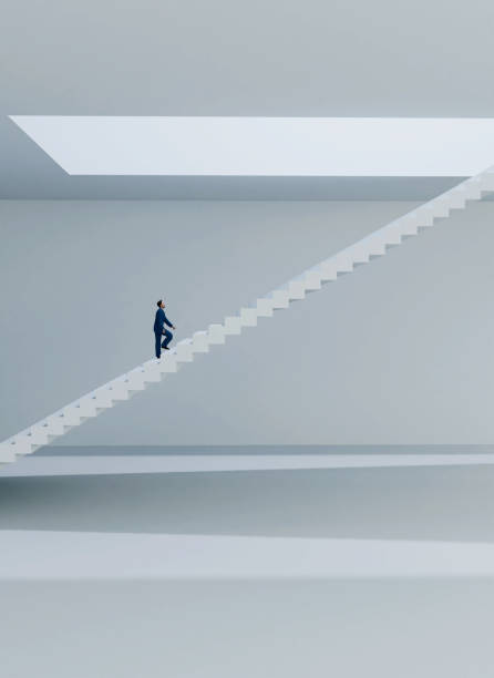istock Businessman walks on staircase towards the light 1363114419
