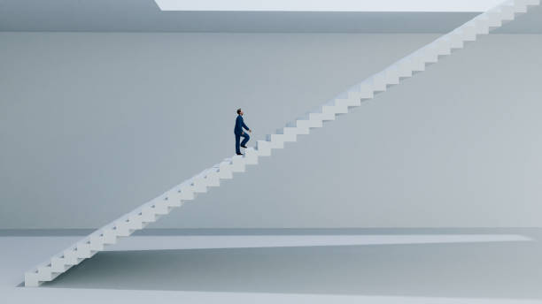 istock Businessman walks on staircase towards the light 1363114438