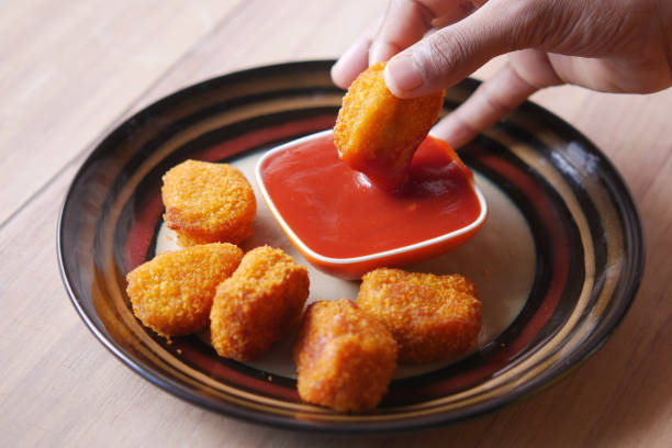 istock close up of chicken nugget and sauce on table 1363114650