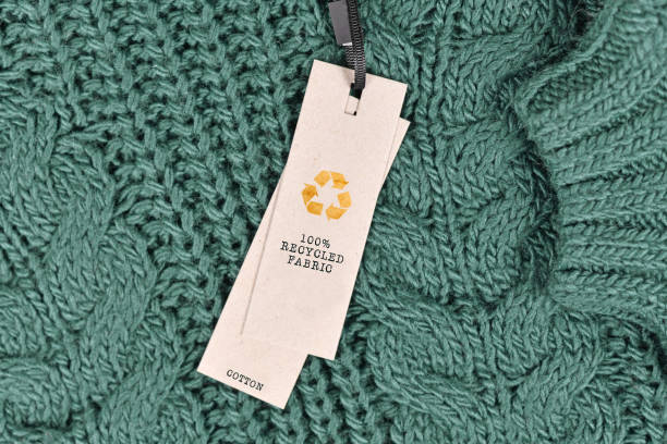 tessuto di cotone con etichetta che dice "tessuto riciclato al 100%" - industria tessile foto e immagini stock