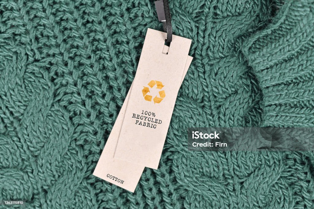 Cotton fabric with label saying '100% recycled fabric' Sustainable Fashion Stock Photo