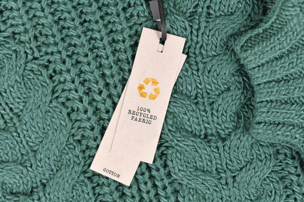 cotton fabric with label saying '100% recycled fabric' - recycling recycling symbol environment environmental conservation imagens e fotografias de stock