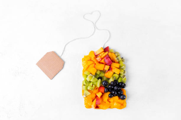 frutas y bayas picadas variadas que hacen una forma de bolsa de té - nectarine peaches peach abstract fotografías e imágenes de stock