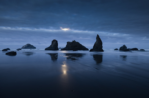 Pre-dawn moonrise over the sea stacks at Bandon Beach.  Located in Bandon, Oregon.