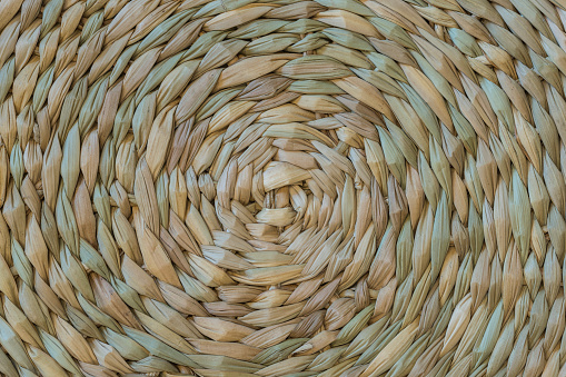 The spiral pattern of woven reed placemat