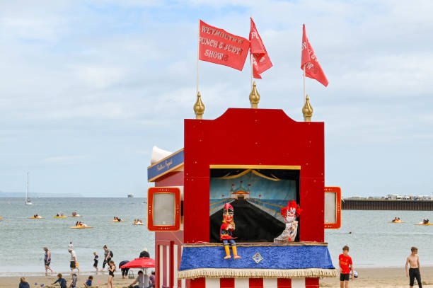 Weymouth, England - July 2021: Traditional Punch and Judy puppet show on the beach in  the tourist resort of Weymouth in Dorset.