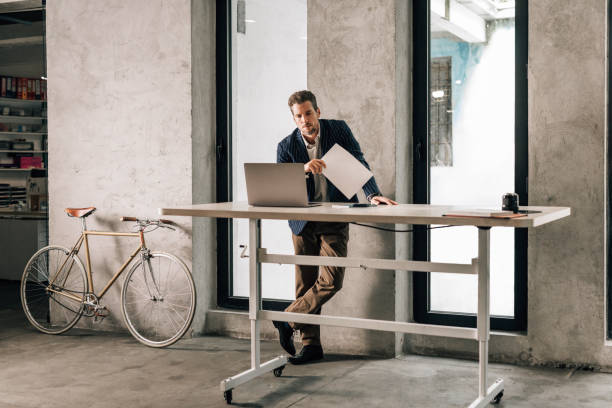istock Businessman in a Suit Working at a Standing Desk 1363123412