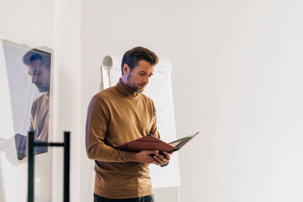 istock Handsome Young Businessman Giving a Presentation on his Project at Work 1363123428