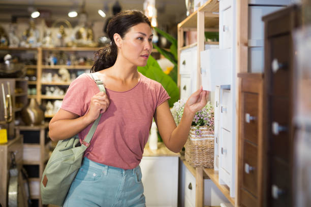 istock Asian female choosing wooden commode in store 1363123564