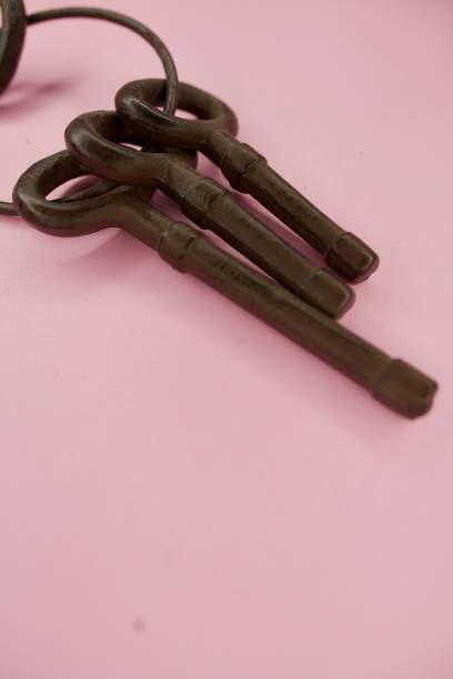 istock Large Wrought iron keys against pink background 1363124333
