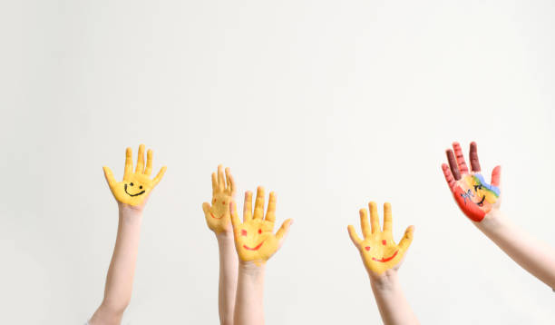 istock Close children's hands painted with yellow paint 1363124465