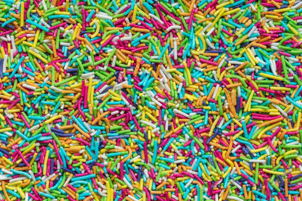 istock Tiny rod-shaped bits of candy used in the bakery as cakes topping. Rainbow sprinkles top view 1363124532