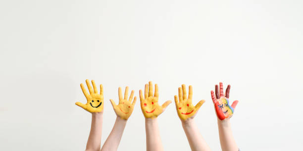 istock Close children's hands painted with yellow paint 1363124583
