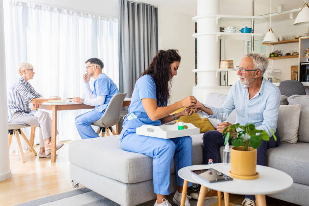 istock Female nurse talking to seniors patients while being in a home visit. 1363128157