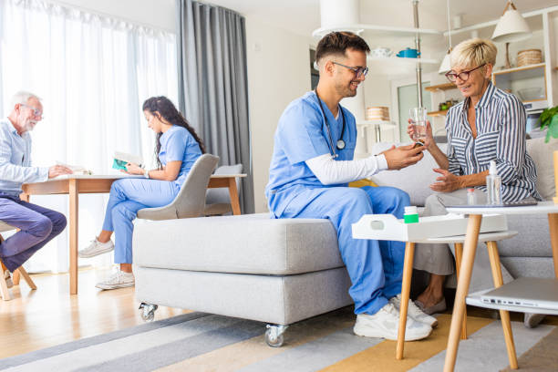 istock Male nurse talking to seniors patients while being in a home visit. 1363128455