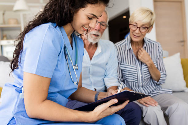 istock Female nurse talking to seniors patients while being in a home visit. 1363128547