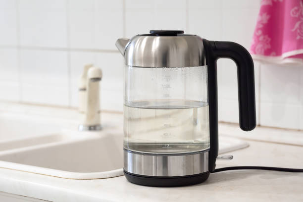 istock Glass transparent kettle with boiled water in the kitchen. 1363130762