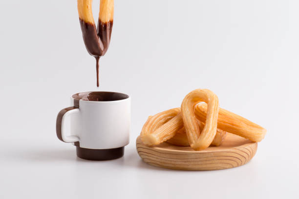 dripping chocolate, dipped in churros stock photo
