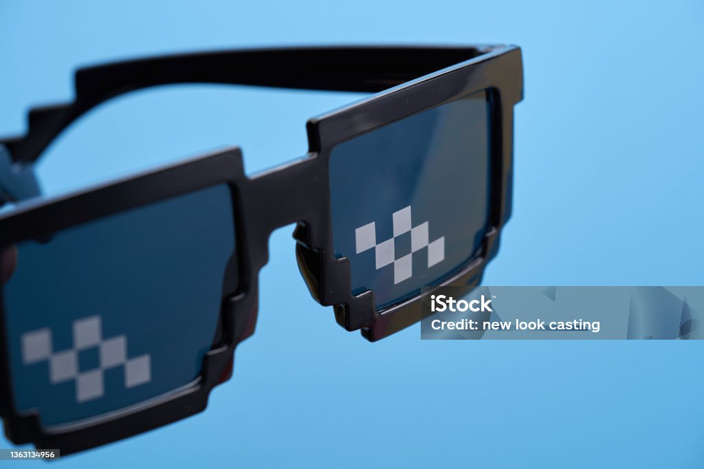 Funny pixelated boss sunglasses on blue background. Eyeglasses Stock Photo