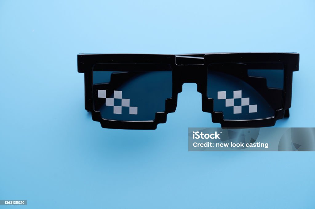 Funny pixelated boss sunglasses on blue background. Pixelated Stock Photo