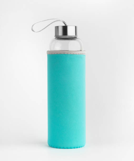 istock Glass water bottle with green protective case. Isolated on a white background. 1363136734