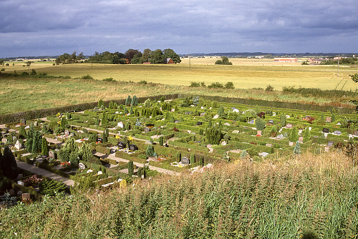 Billund, Denmark - aug 17, 1987: a tidy country cemetery is located near Randbøl Church near Billund in Denmark