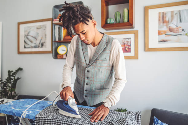 istock Young man ironing his shirt 1363136851