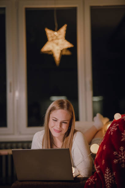 istock Young woman using laptop at night at home 1363137080
